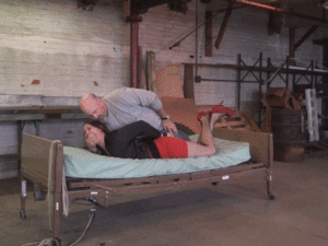 xsiteability.com - Pushed onto the bed then bound, gagged and painfully hogtied thumbnail